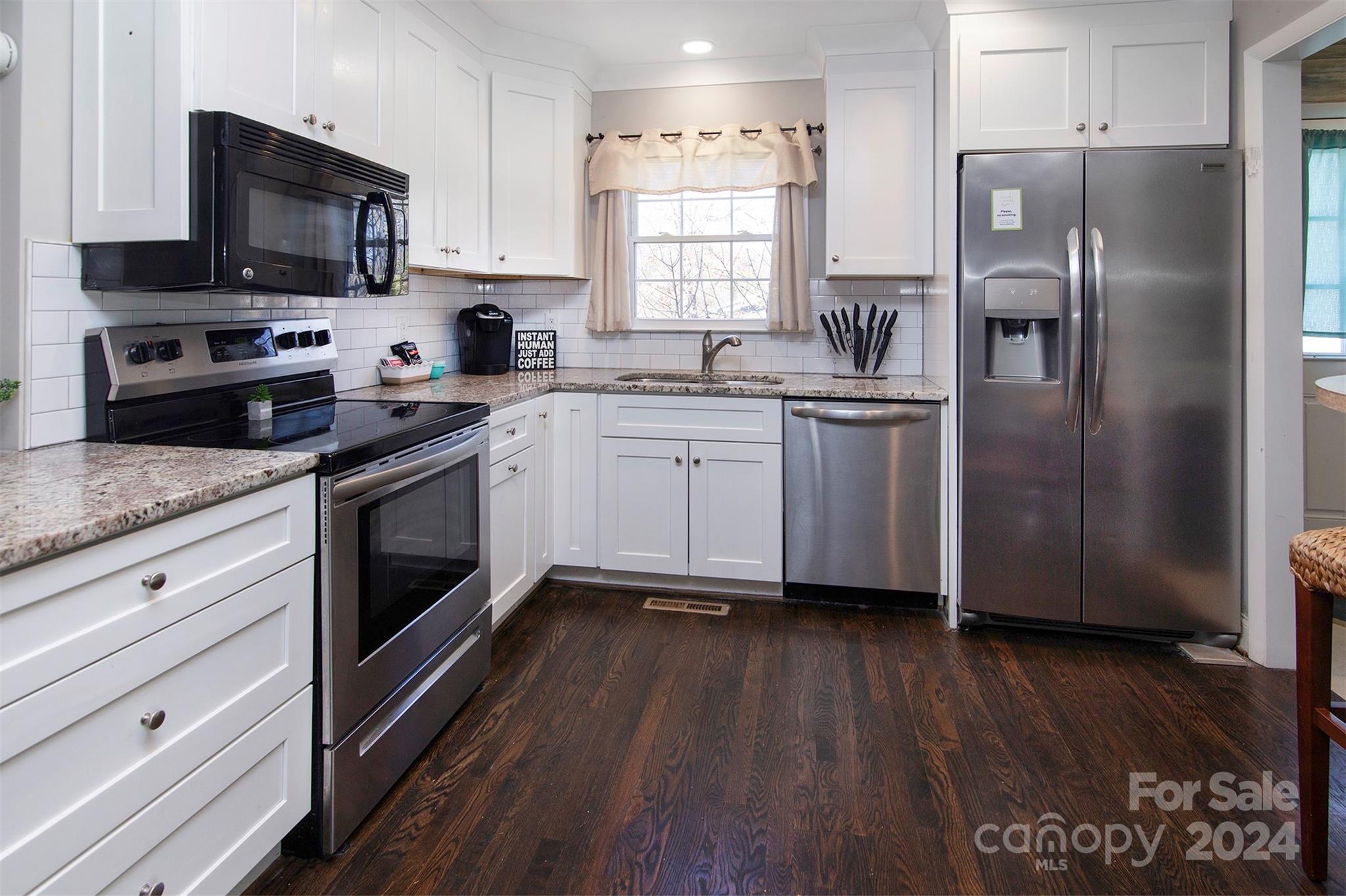 3741 Woodleaf Road Charlotte, NC 28205 - Photo 2 of 31 a kitchen with stainless steel appliances granite countertop a refrigerator a stove a sink and a microwave