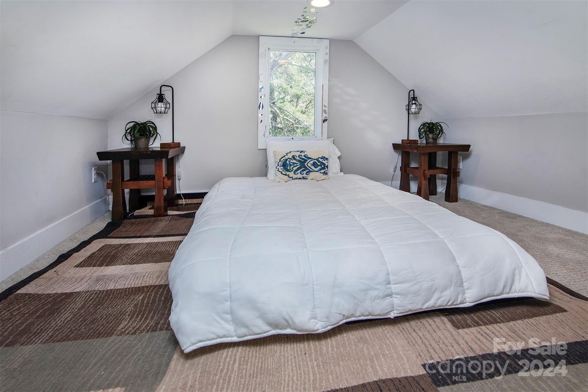 3741 Woodleaf Road Charlotte, NC 28205 - Photo 26 of 31 a bedroom with a bed and a window