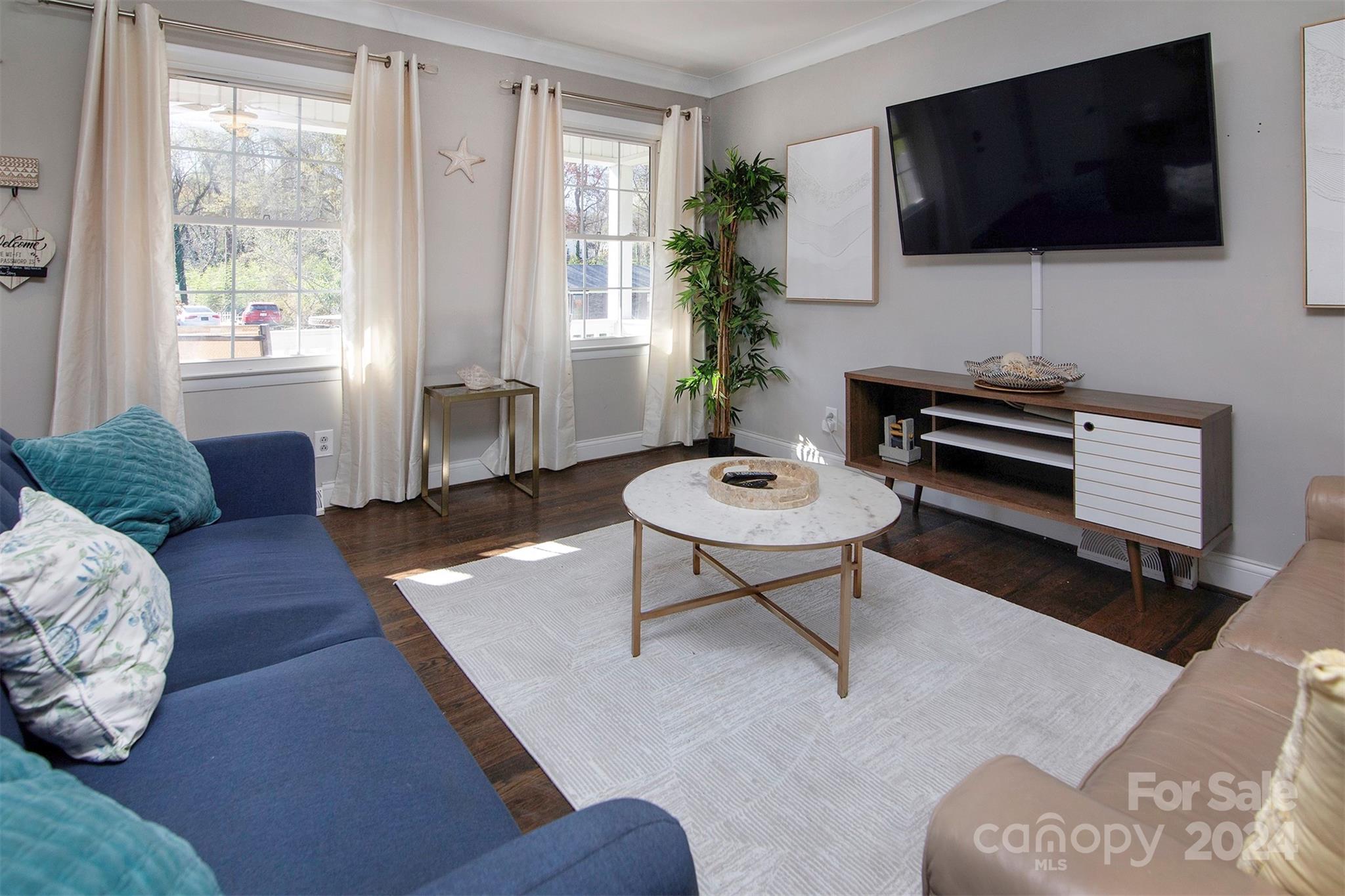 3741 Woodleaf Road Charlotte, NC 28205 - Photo 4 of 31 a living room with furniture and a flat screen tv