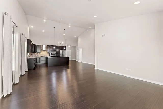 a view of kitchen with refrigerator and stove
