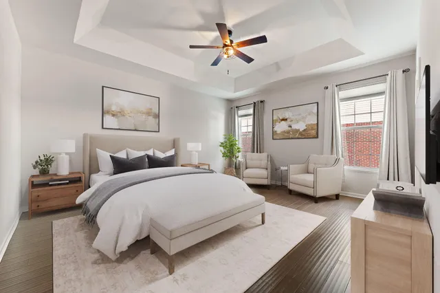 a bedroom with a bed couches and window