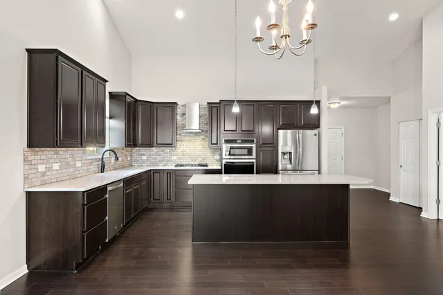 a kitchen with stainless steel appliances a sink stove and refrigerator