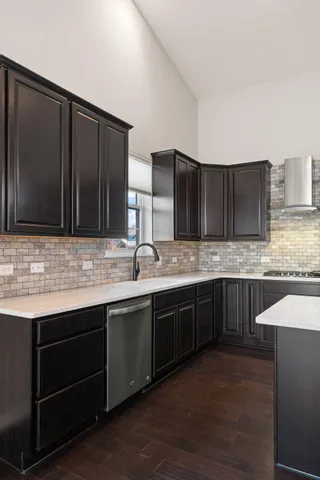 a kitchen with stainless steel appliances granite countertop wooden cabinets a sink and dishwasher