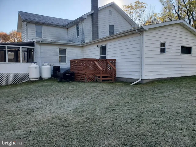 a view of a house with a yard and sitting area