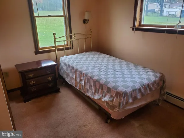 a bed sitting in a bedroom next to a window