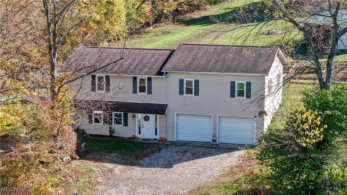 4244 Murray Road Dover, OH 44622 - Photo 2 of 29 View of front of house with gravel driveway and an attached garage