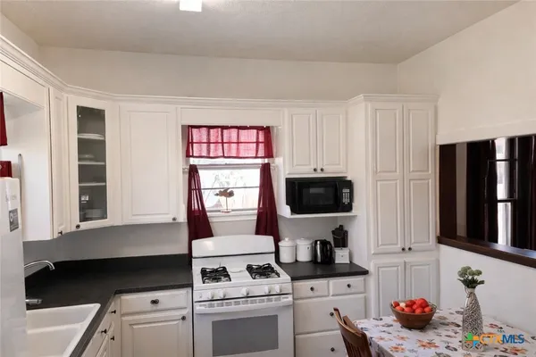 a kitchen with stainless steel appliances a stove and a microwave