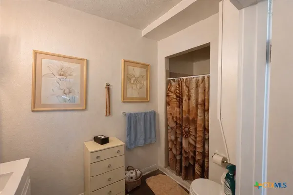 a bathroom with a toilet sink and shower