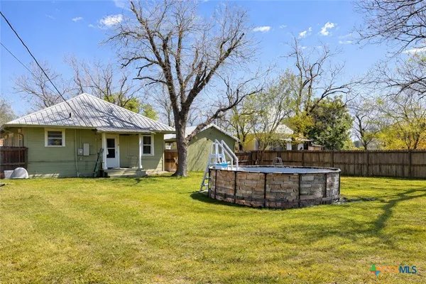 a front view of a house with a garden and outdoor seating