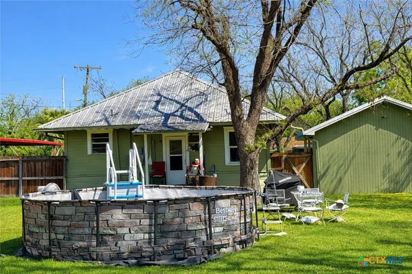 a view of a house with backyard porch and sitting area