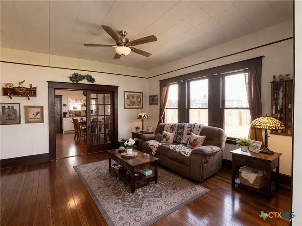 a living room with furniture and wooden floor