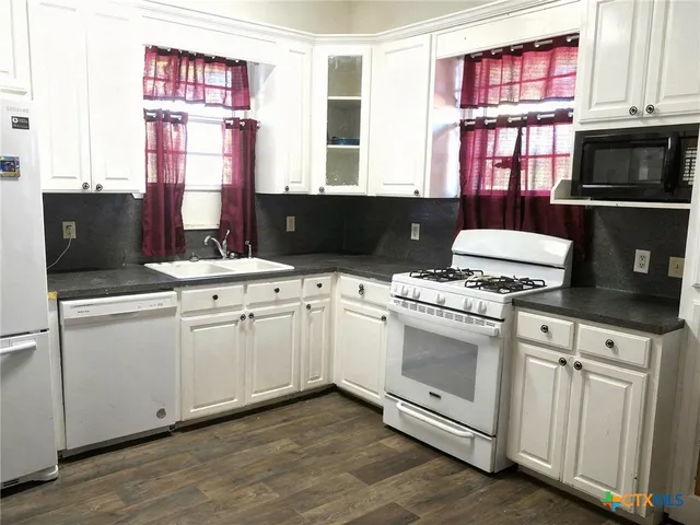 a kitchen with a stove and a sink
