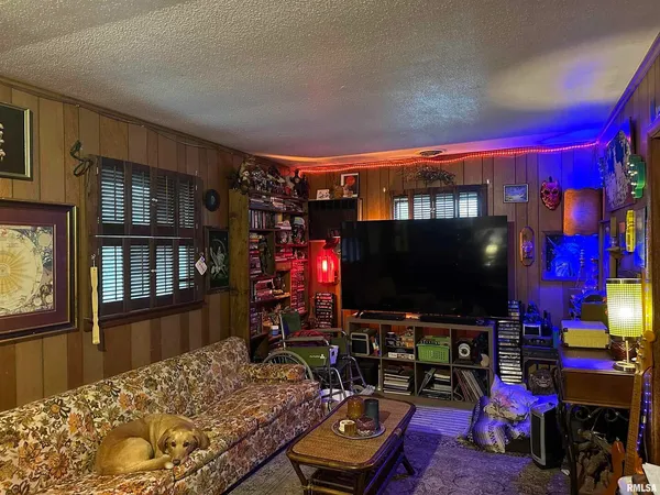 a bedroom with a bed and flat screen tv