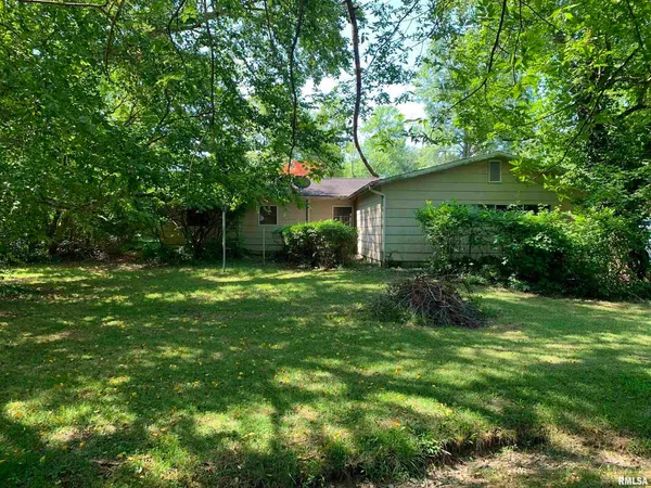a house view with a sitting space and garden