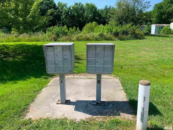 a front view of a house with swing and a garden