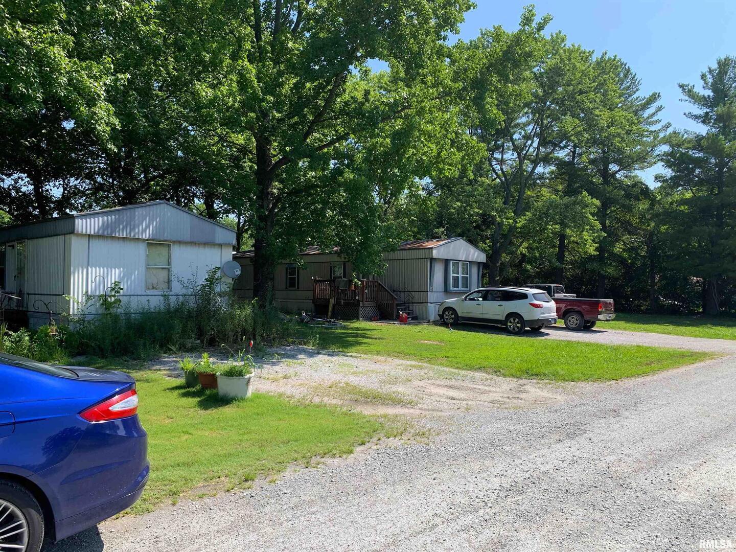 5281-5287 Country Club Road, Unit 1 2 Murphysboro, IL 62966 - Photo 27 of 50 a front view of a house with swing and a garden