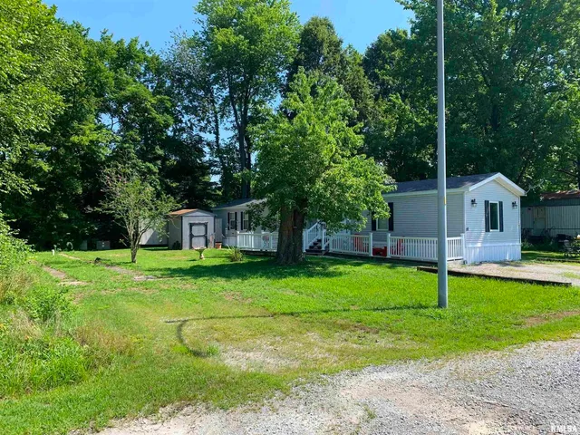 a view of a backyard with large trees