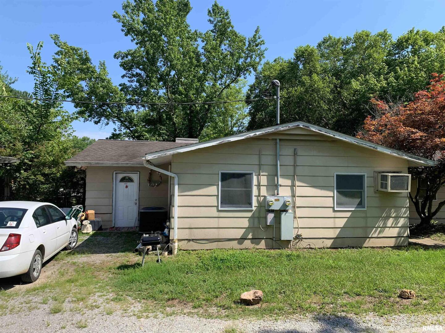 5281-5287 Country Club Road, Unit 1 2 Murphysboro, IL 62966 - Photo 6 of 50 a view of a yard in front of a house with plants and large tree