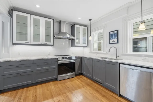 a kitchen with stainless steel appliances granite countertop a stove and a sink