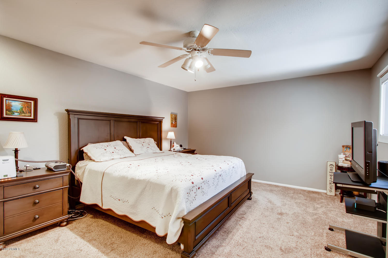 5945 East Thomas Road Scottsdale, AZ 85251 - Photo 12 of 33 a bedroom with a bed and a chandelier