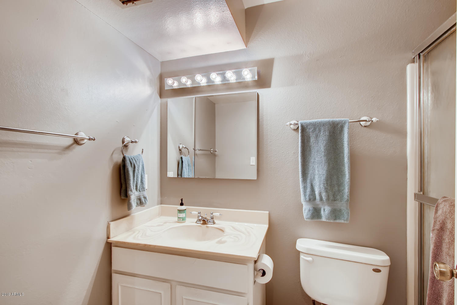 5945 East Thomas Road Scottsdale, AZ 85251 - Photo 14 of 33 a bathroom with a sink a toilet and mirror