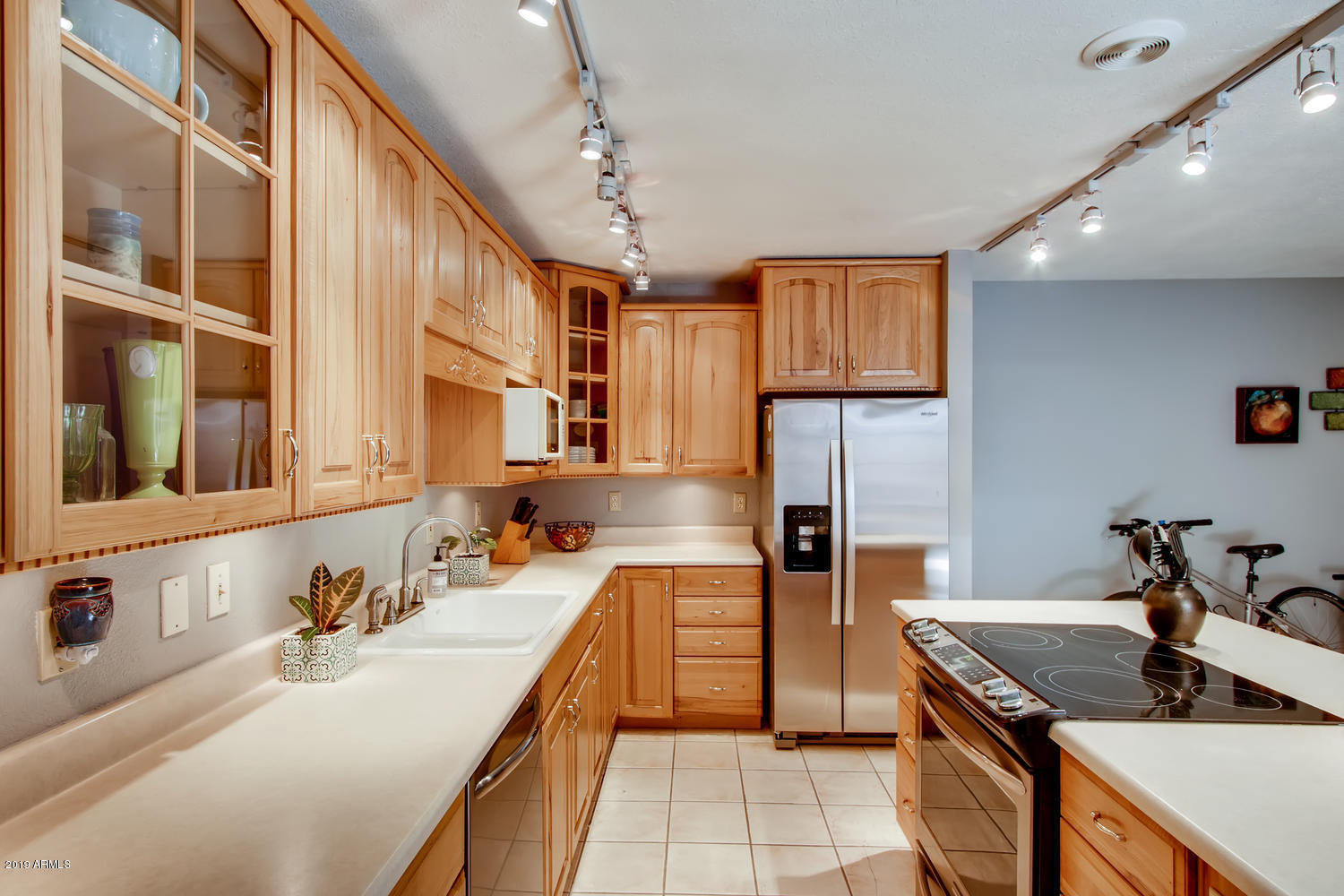 5945 East Thomas Road Scottsdale, AZ 85251 - Photo 8 of 33 a kitchen with stainless steel appliances granite countertop a sink stove and refrigerator