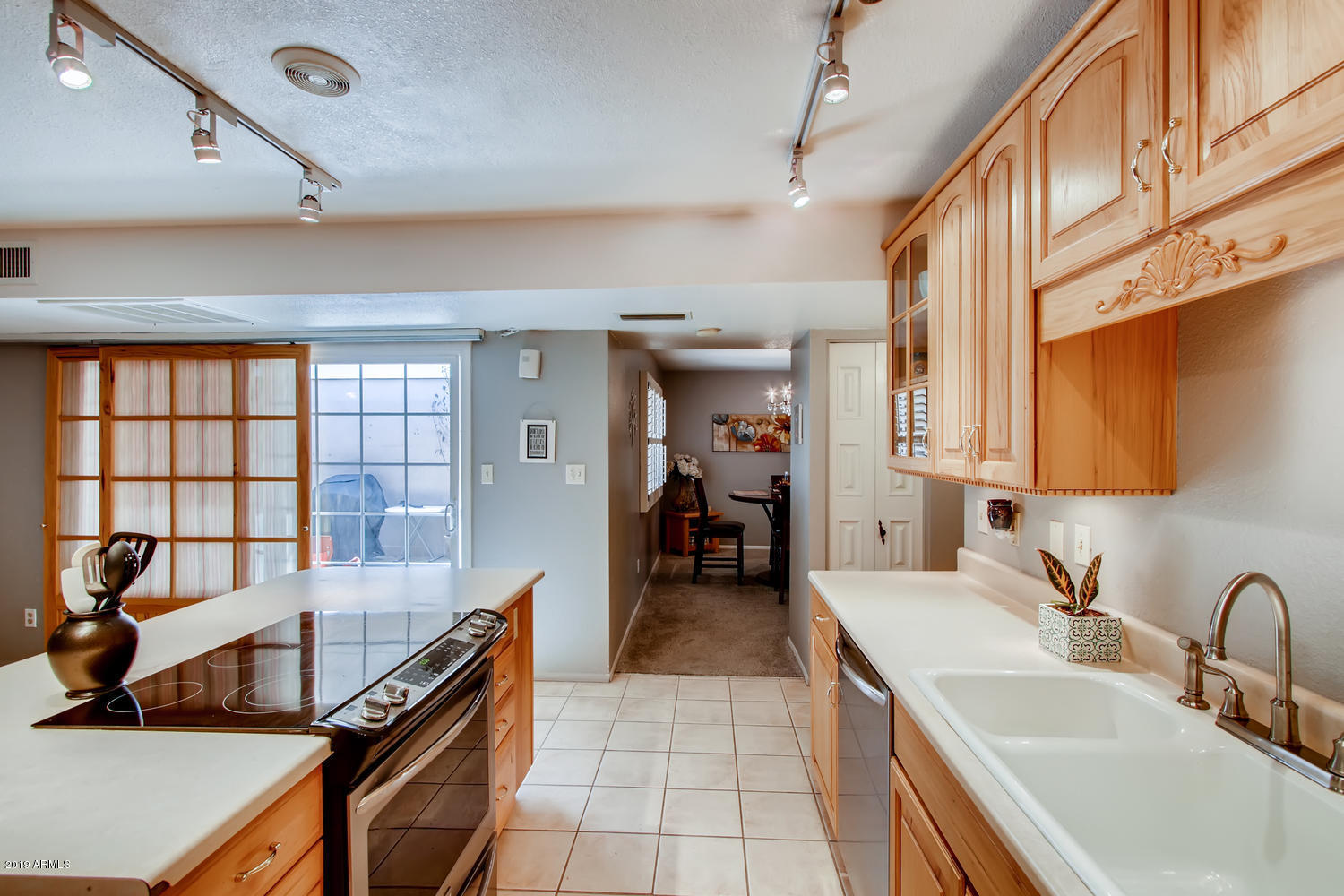 5945 East Thomas Road Scottsdale, AZ 85251 - Photo 9 of 33 a kitchen with a sink and a stove top oven