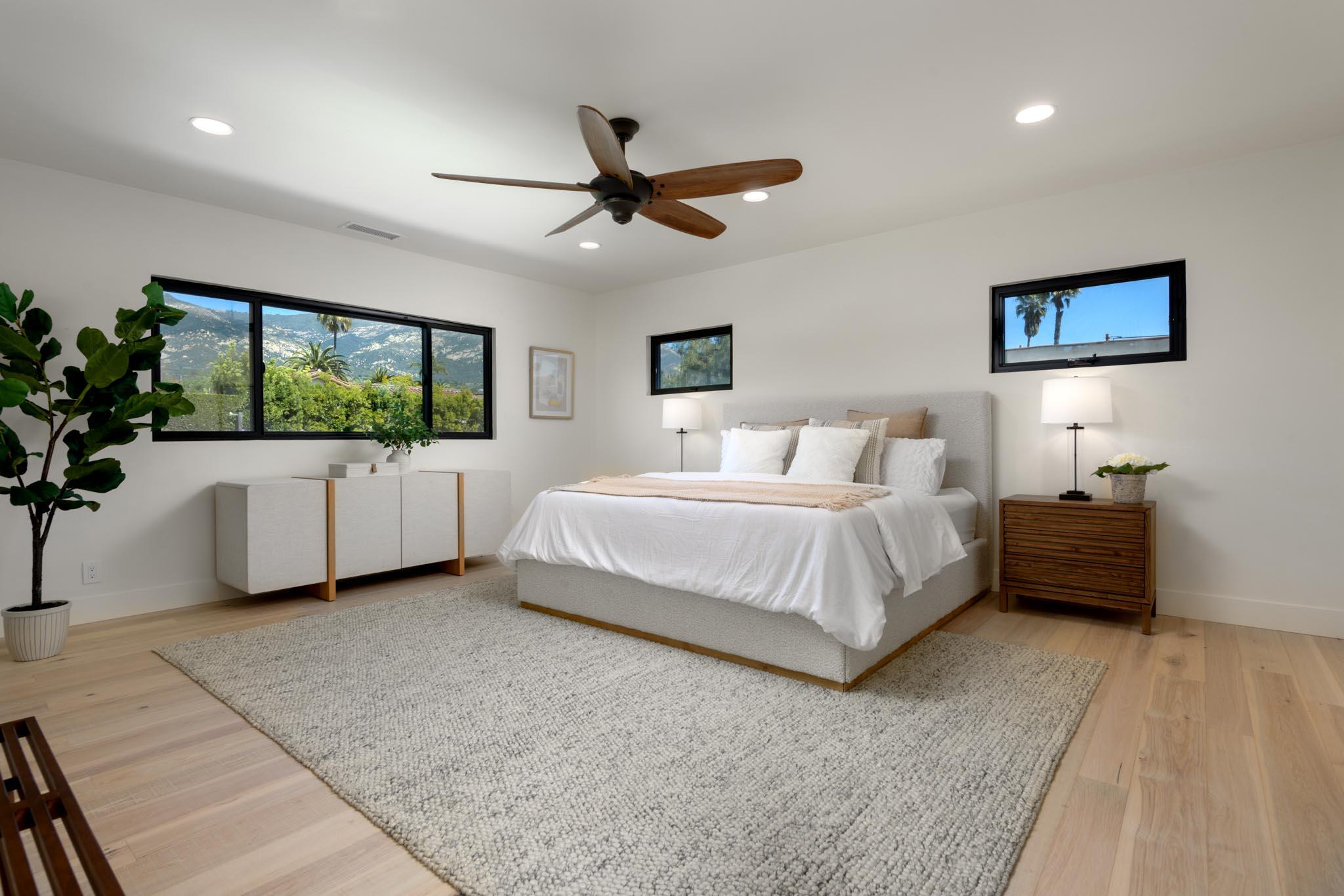 3816 Sunset Road Santa Barbara, CA 93110 - Photo 22 of 38 a bedroom with a large bed and a chandelier