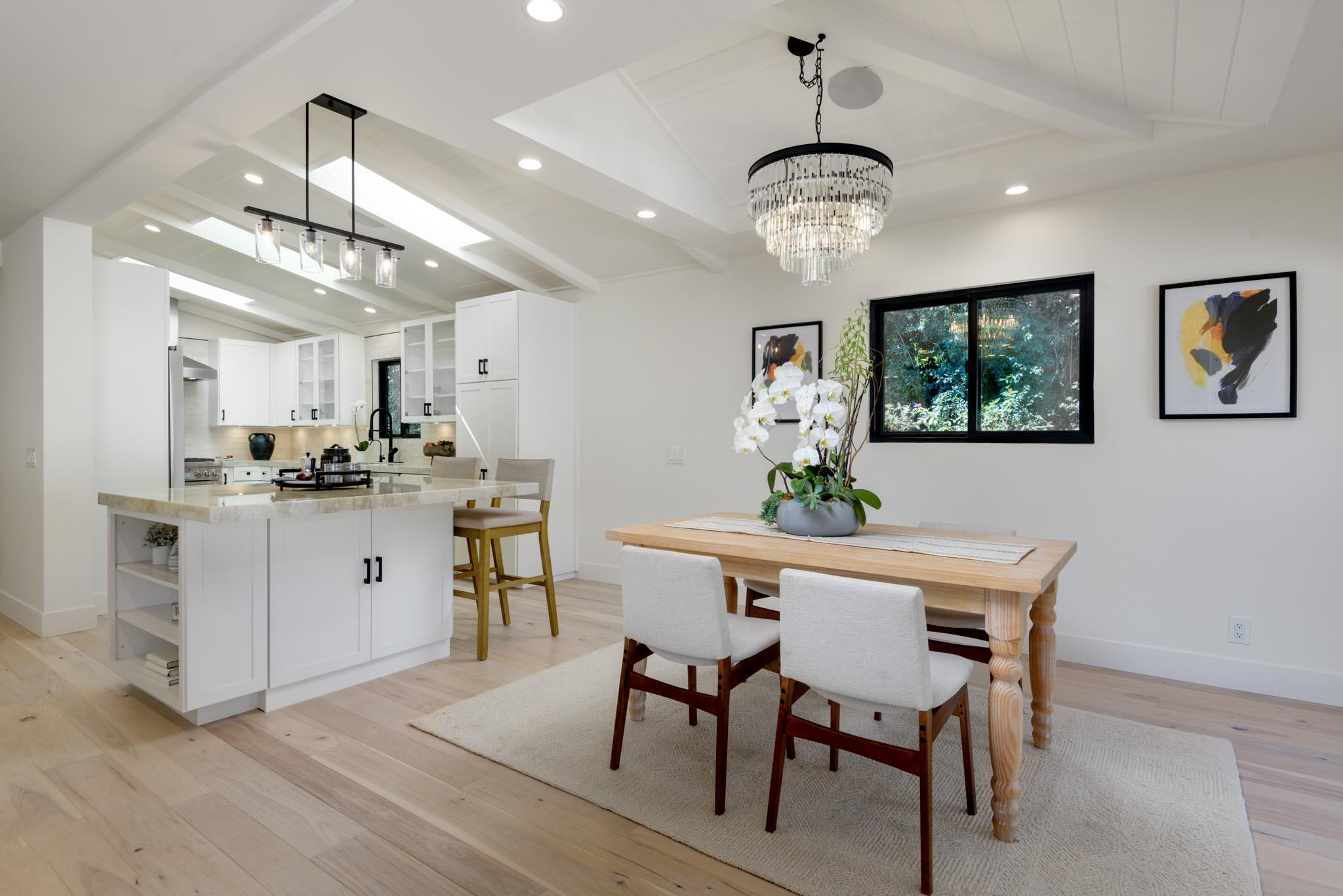 3816 Sunset Road Santa Barbara, CA 93110 - Photo 6 of 38 a kitchen with stainless steel appliances kitchen island granite countertop a dining table chairs and white cabinets