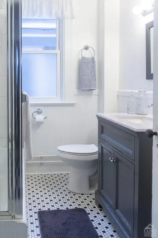 a bedroom with furniture and a window