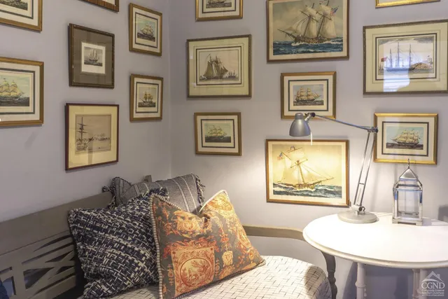 a bedroom with a bed and a painting on the wall