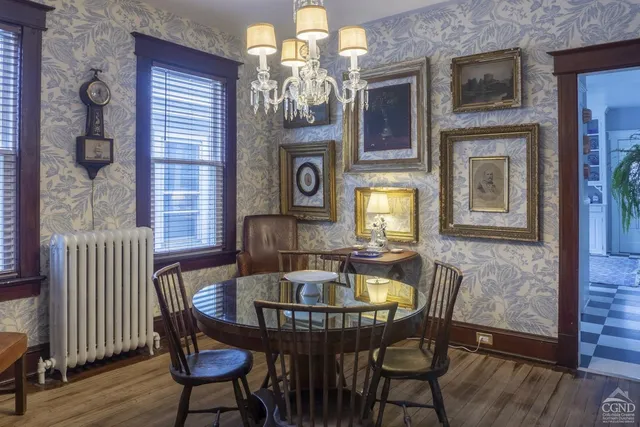 a view of a dining room with furniture and chandelier