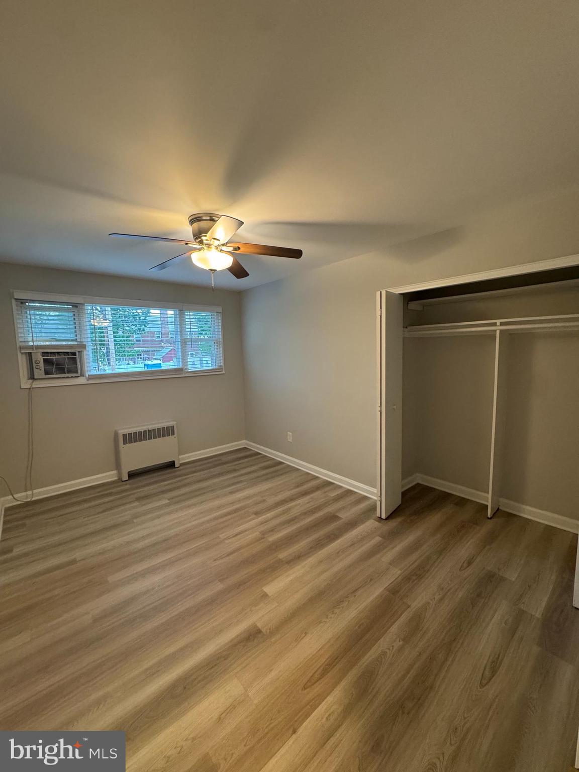 500 South Courthouse Road, Unit 5 Arlington, VA 22204 - Photo 5 of 16 an empty room with wooden floor and windows
