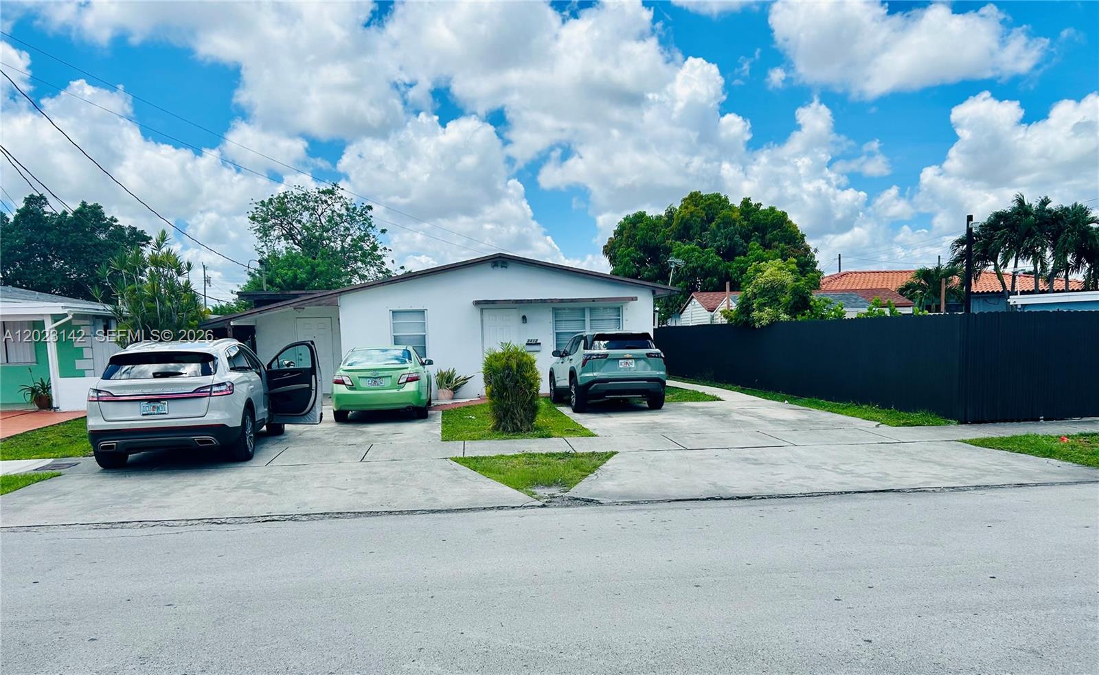 3410 Southwest 89th Court Miami, FL 33165 - Photo 2 of 18 a front view of a house with a garden and trees