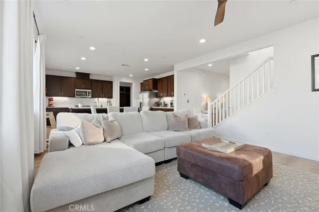 a large kitchen with kitchen island a large counter top space a sink a stove and a refrigerator