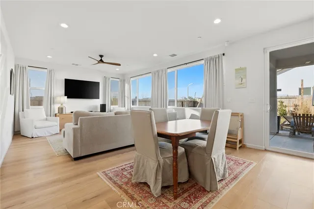 a kitchen with a table chairs refrigerator and microwave