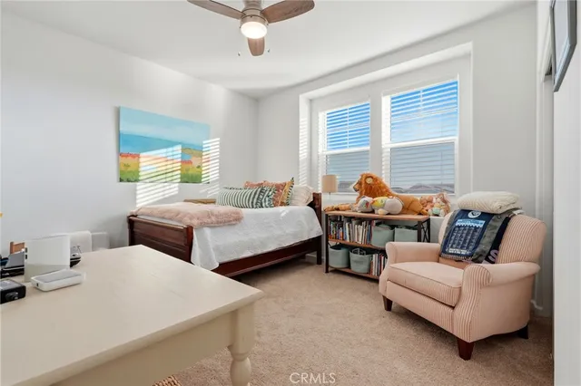 a bathroom with a granite countertop sink a toilet and a mirror