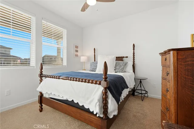 a bathroom with a granite countertop sink a toilet and a mirror