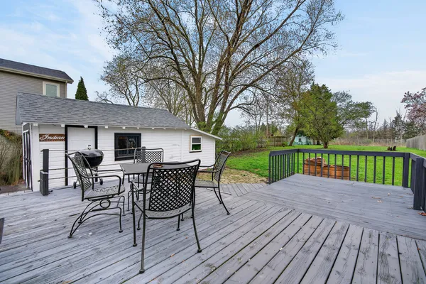 a view of a deck with table and chairs and wooden floor