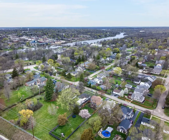 an aerial view of residential building and lake