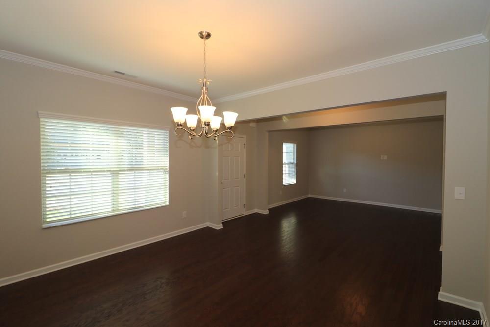 1718 Still River Way, Unit 7 Fort Mill, SC 29708 - Photo 3 of 21 a view of an empty room with wooden floor and a window