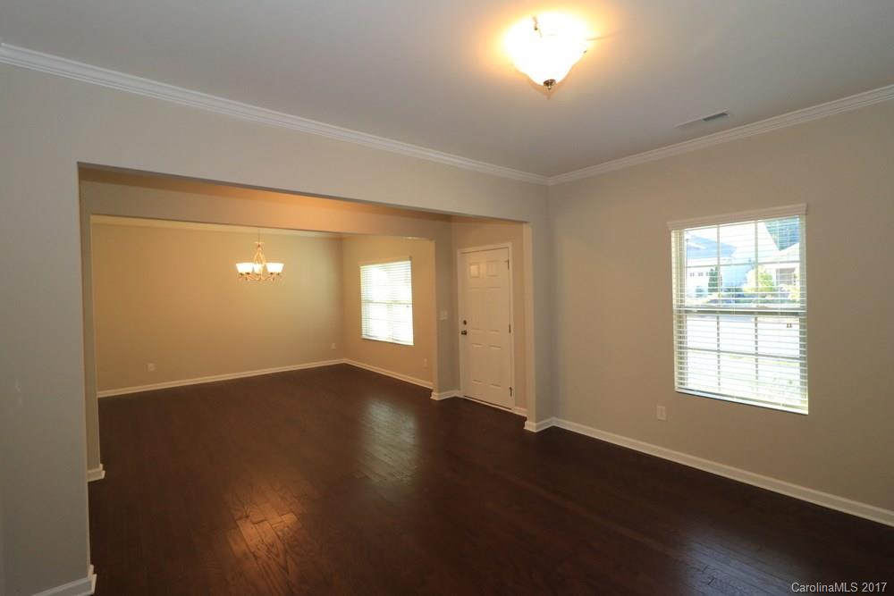 1718 Still River Way, Unit 7 Fort Mill, SC 29708 - Photo 4 of 21 an empty room with wooden floor and windows
