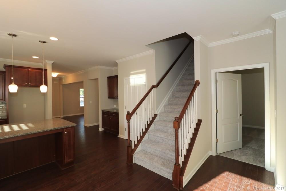 1718 Still River Way, Unit 7 Fort Mill, SC 29708 - Photo 5 of 21 a view of a hallway with wooden floor and staircase