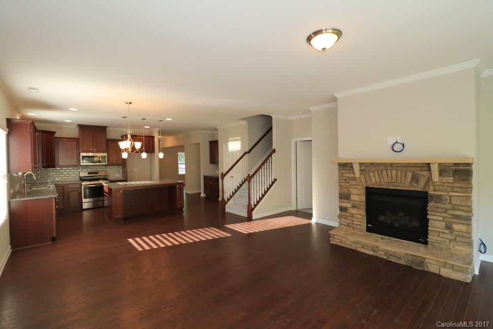 1718 Still River Way, Unit 7 Fort Mill, SC 29708 - Photo 6 of 21 a view of a livingroom with furniture a fireplace and wooden floor