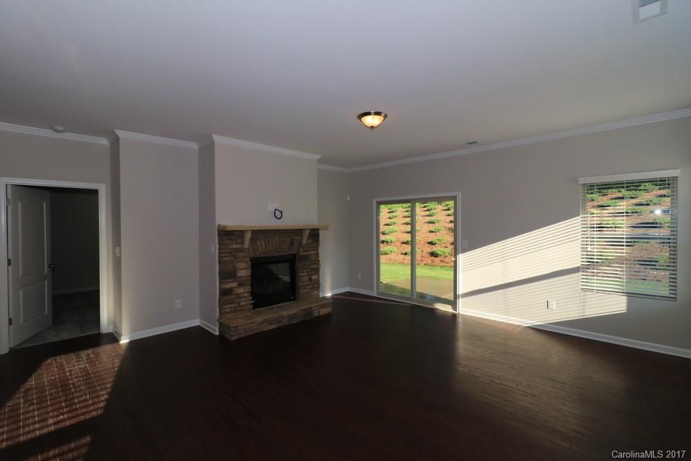 1718 Still River Way, Unit 7 Fort Mill, SC 29708 - Photo 7 of 21 a living room with hard wood floors and a fireplace