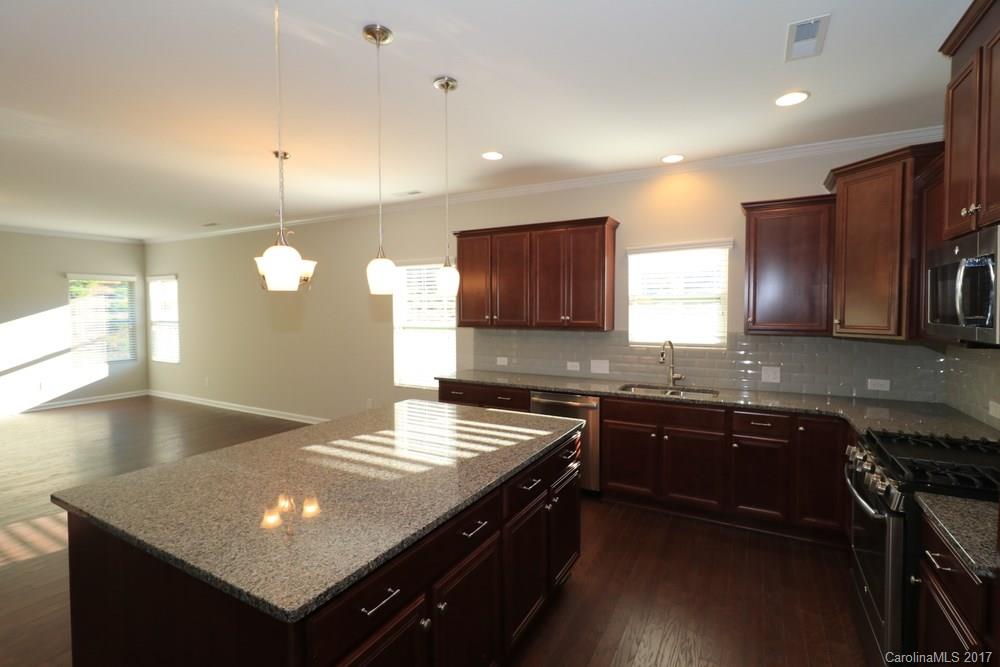 1718 Still River Way, Unit 7 Fort Mill, SC 29708 - Photo 8 of 21 a kitchen with stainless steel appliances granite countertop a sink stove and refrigerator
