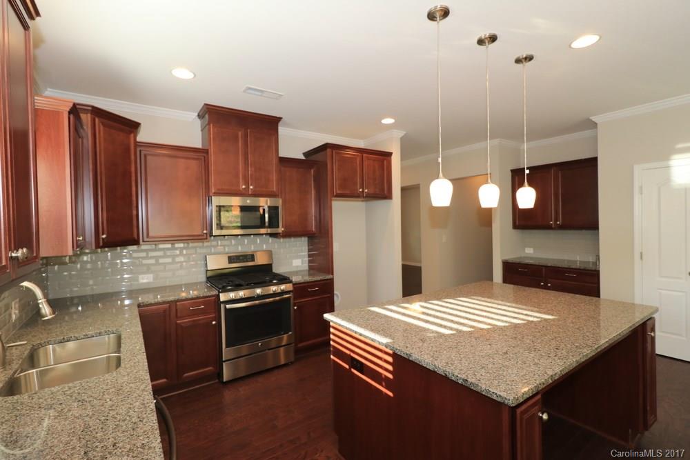 1718 Still River Way, Unit 7 Fort Mill, SC 29708 - Photo 9 of 21 a kitchen with stainless steel appliances granite countertop a sink stove and refrigerator