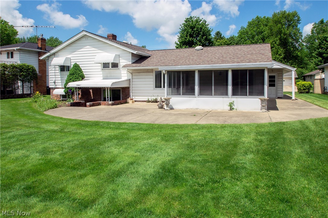 5650 Falkirk Road Lyndhurst, OH 44124 - Photo 26 of 28 Back view of home boasting covered Brick Patio, 3-season Sun Room, and generous patio area. Entertaining delight!