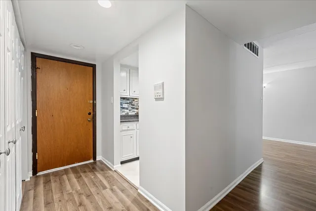 a view of hallway with wooden floor