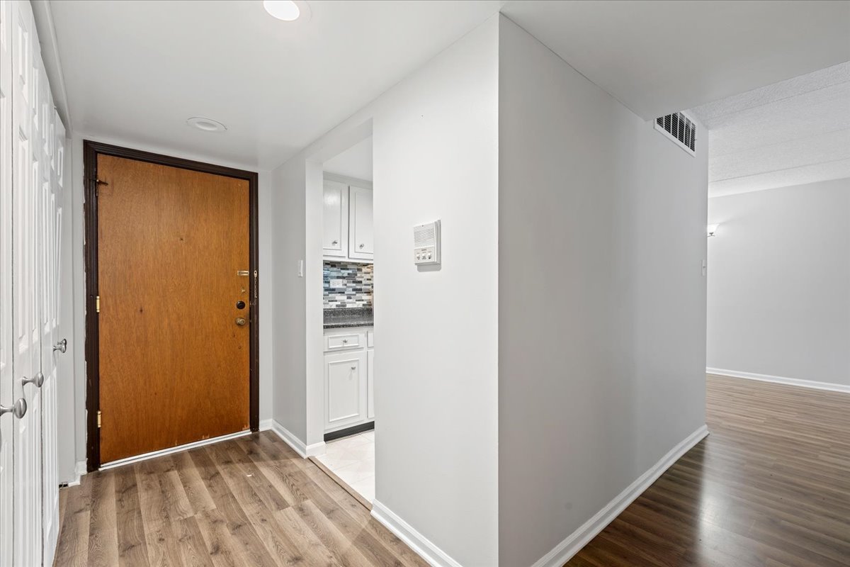 8000 Woodglen Lane, Unit 109 Downers Grove, IL 60516 - Photo 17 of 18 a view of hallway with wooden floor